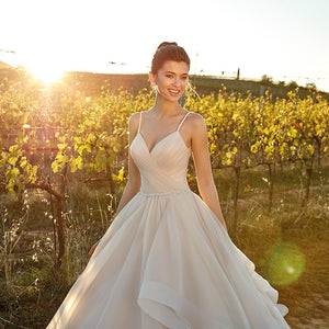 Spaghetti Straps And Tiered Ruffles Flowing Sweep Train Are The Feature Of This Beautiful Dress - A Thrifty Bride Shop